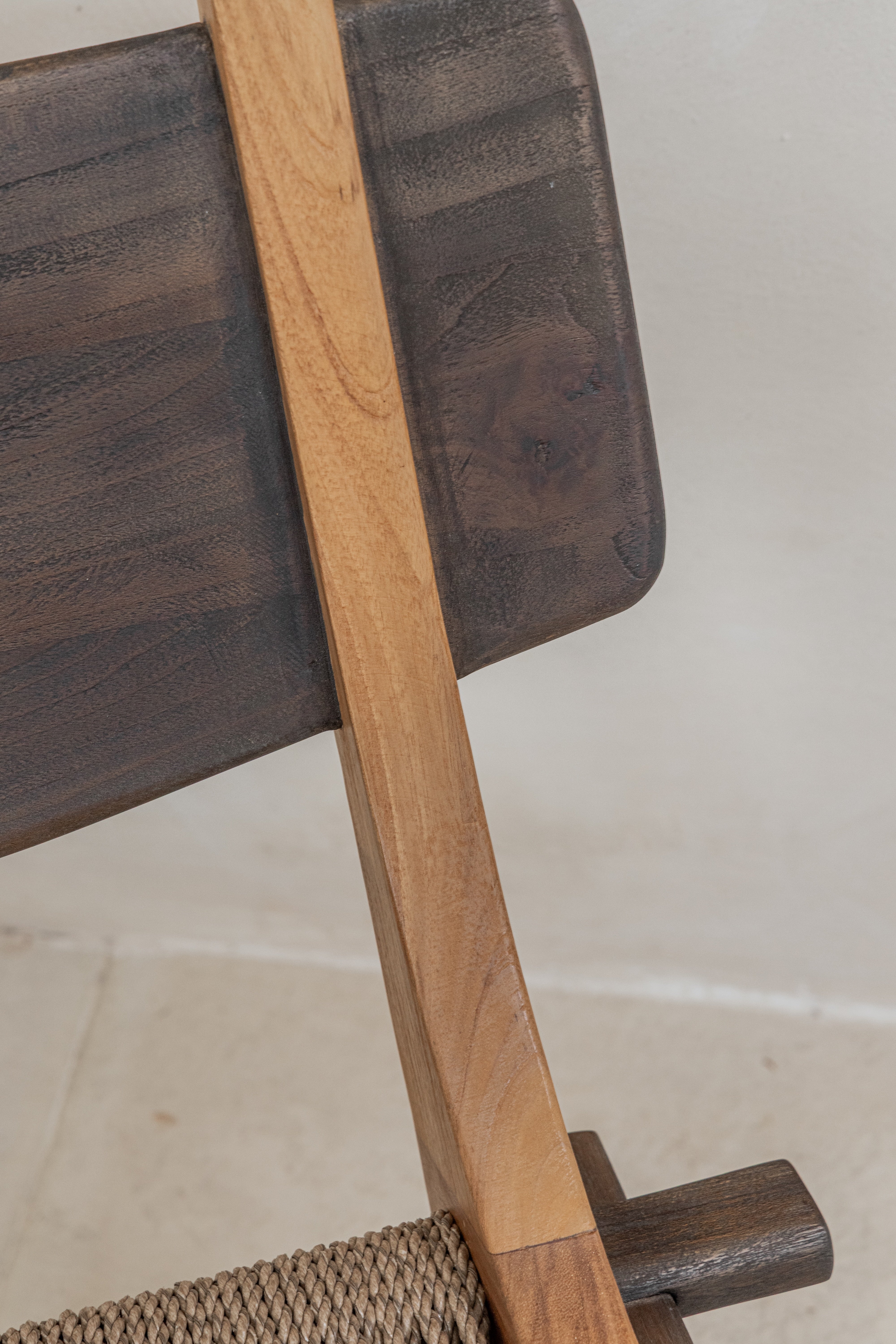 Spanish inspired teak lounge chair with woven rope seat backrest detail