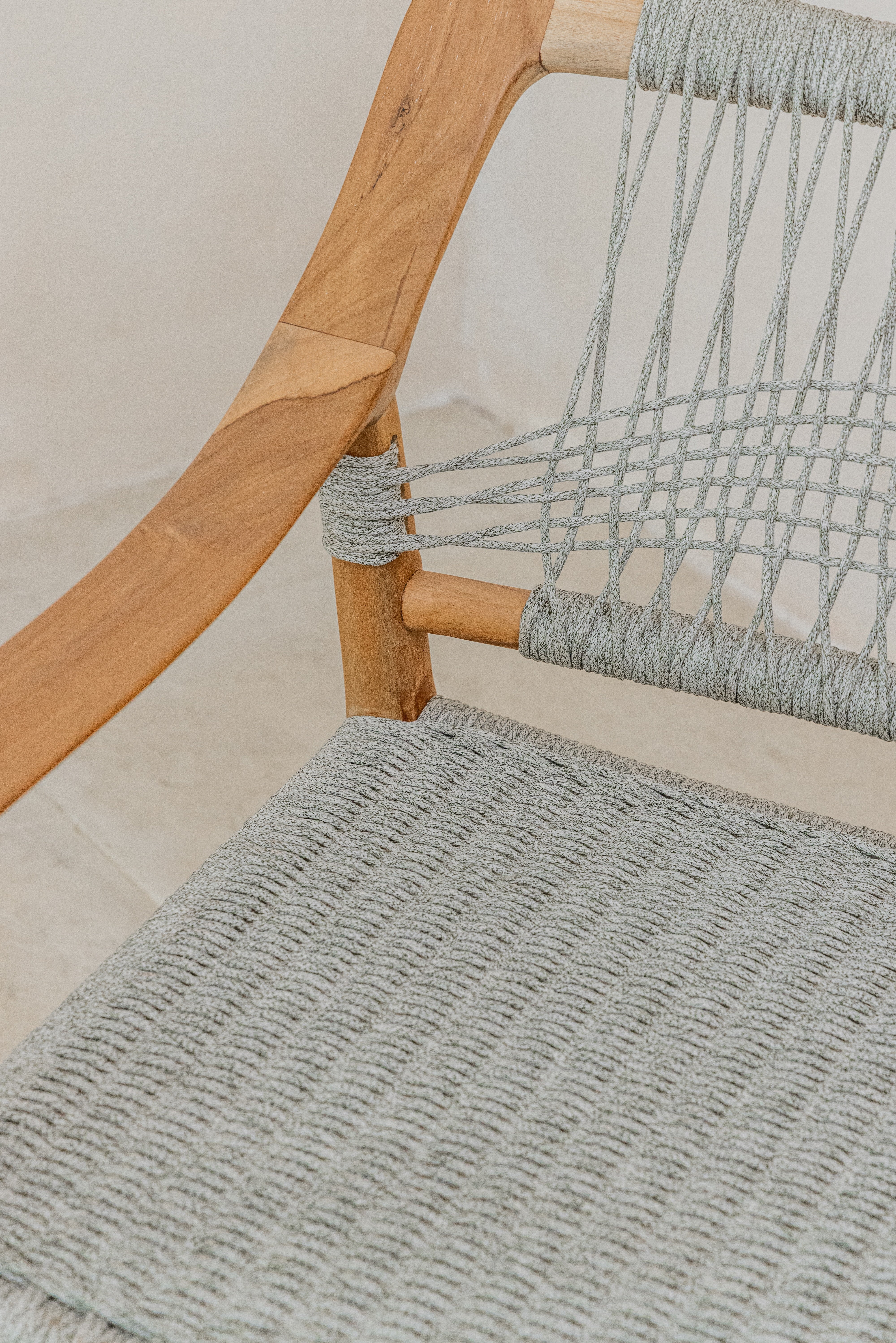 Scandi inspired teak dining chair with a grey woven rope seat arm detail