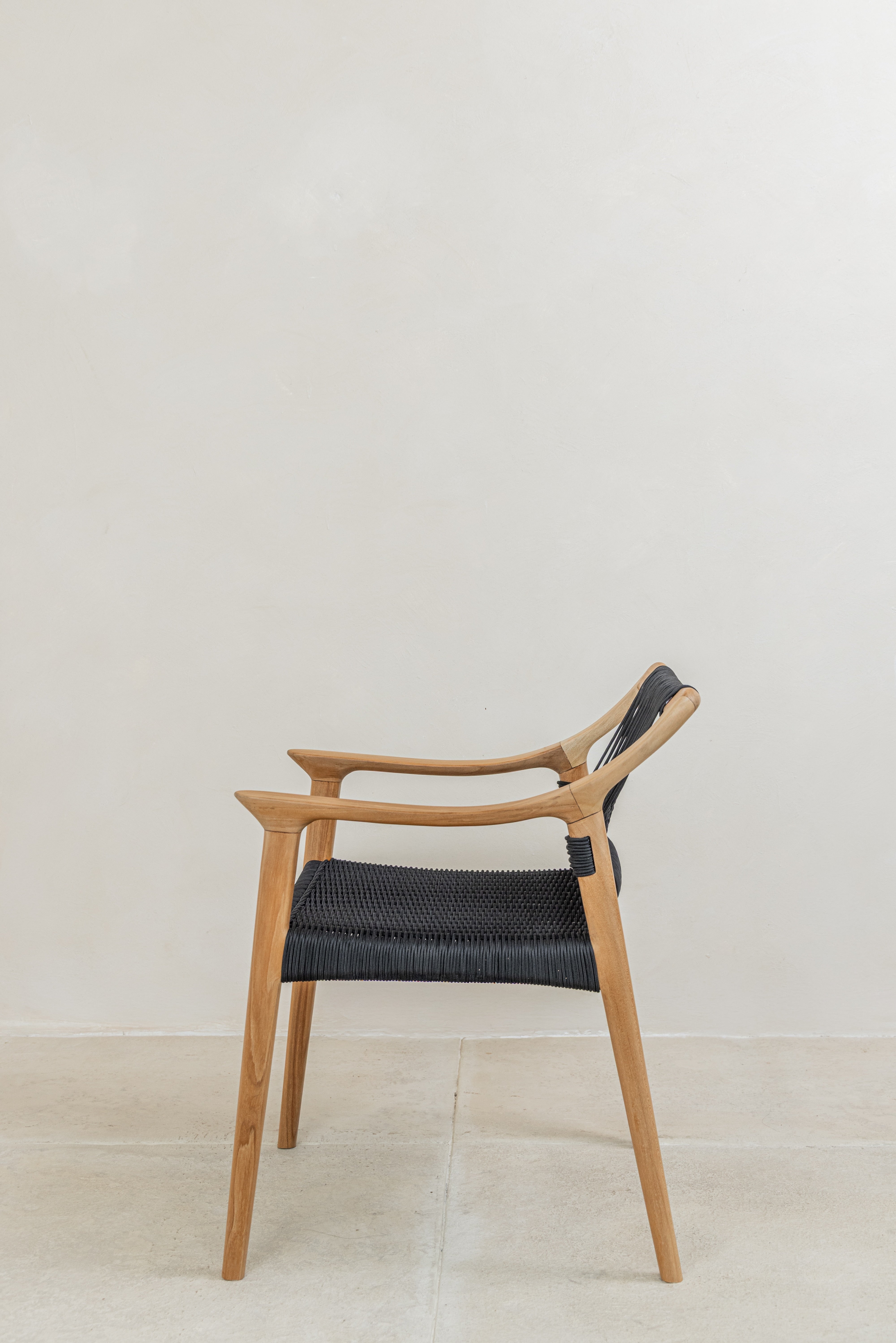 Scandi inspired teak dining chair with black woven rope seat and back side view