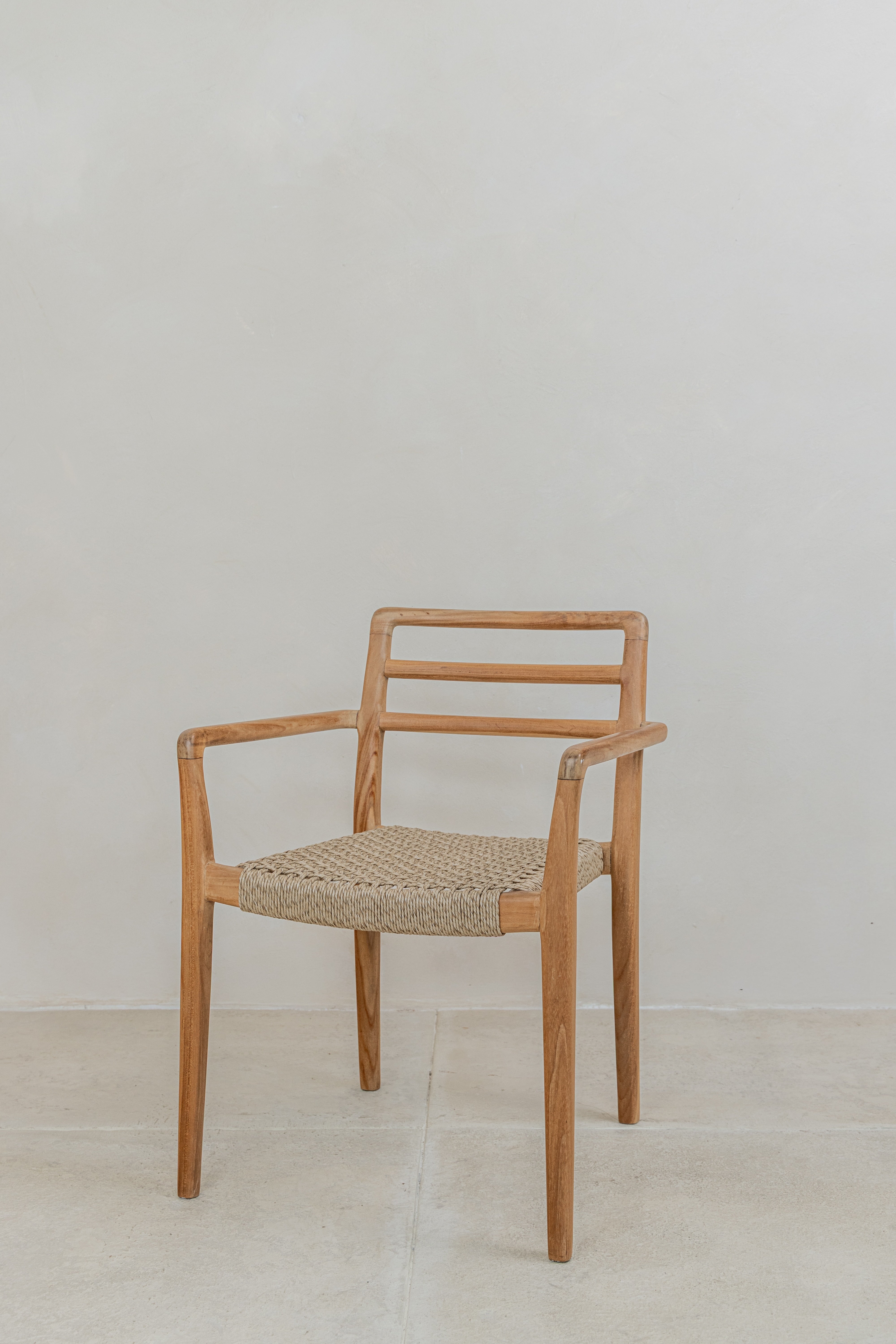 Teak outdoor dining chair with arms and natural woven wicker seat