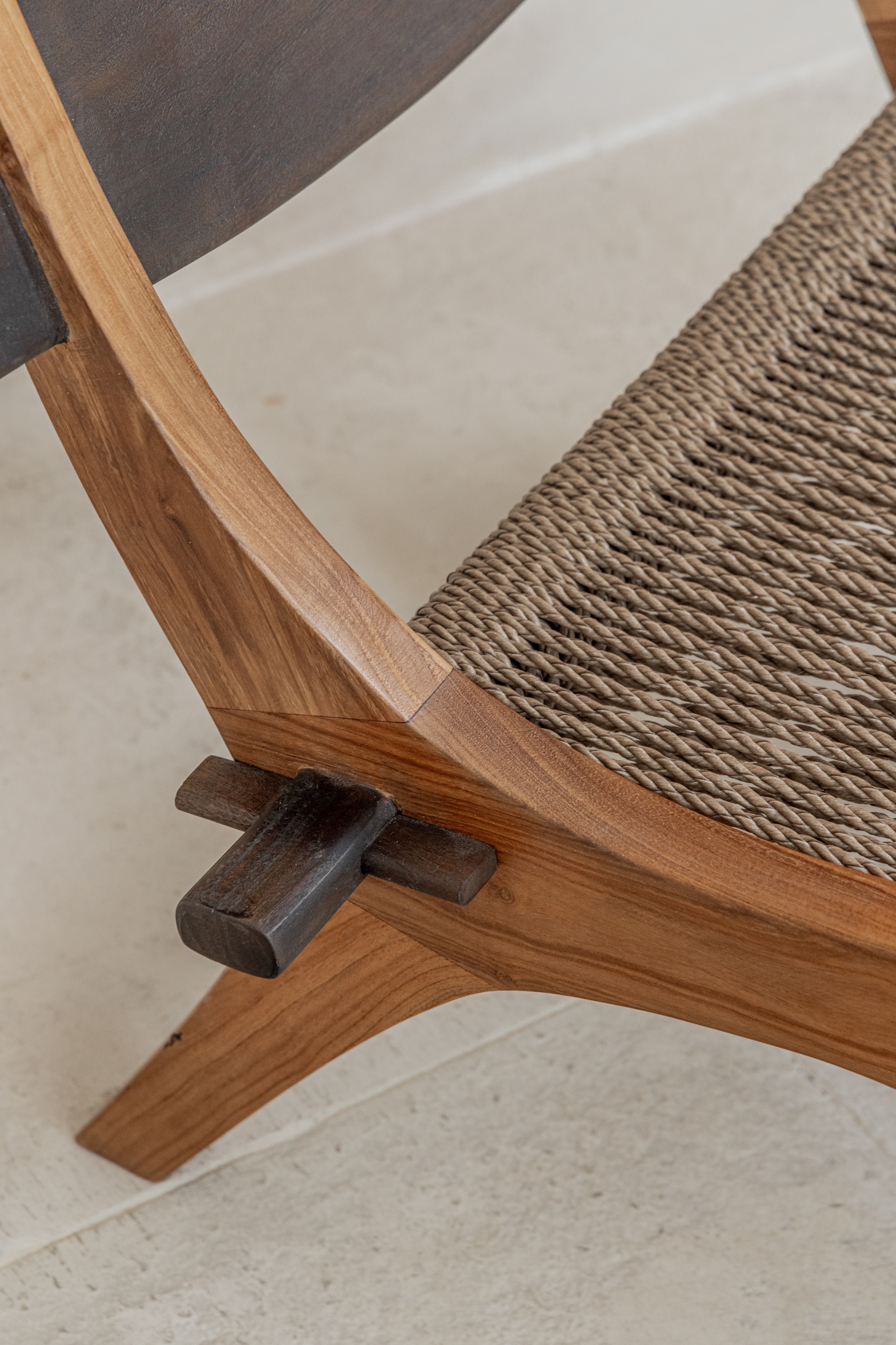 Spanish inspired teak lounge chair with woven rope seat joinery detail