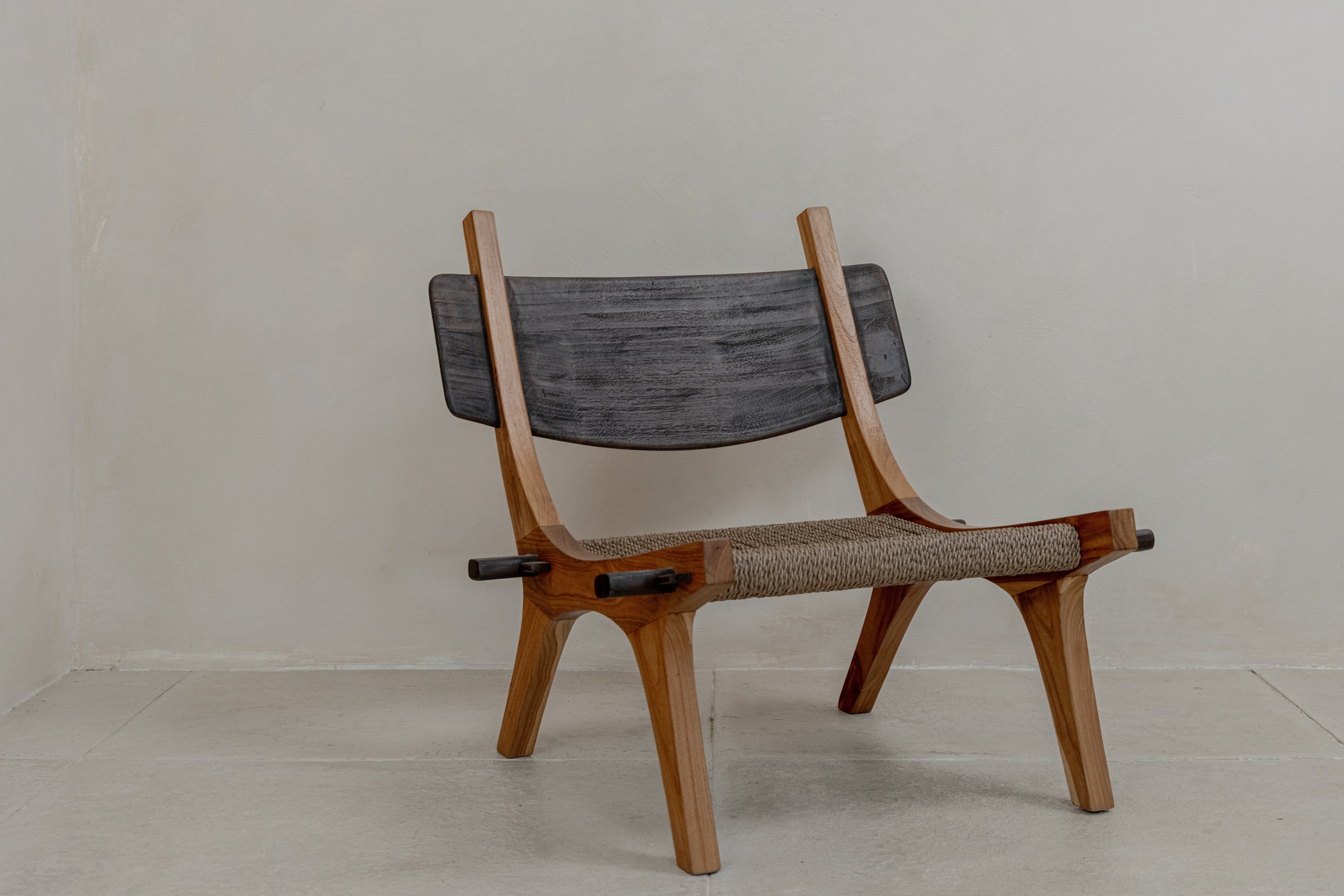 Spanish inspired teak lounge chair with woven rope seat front view
