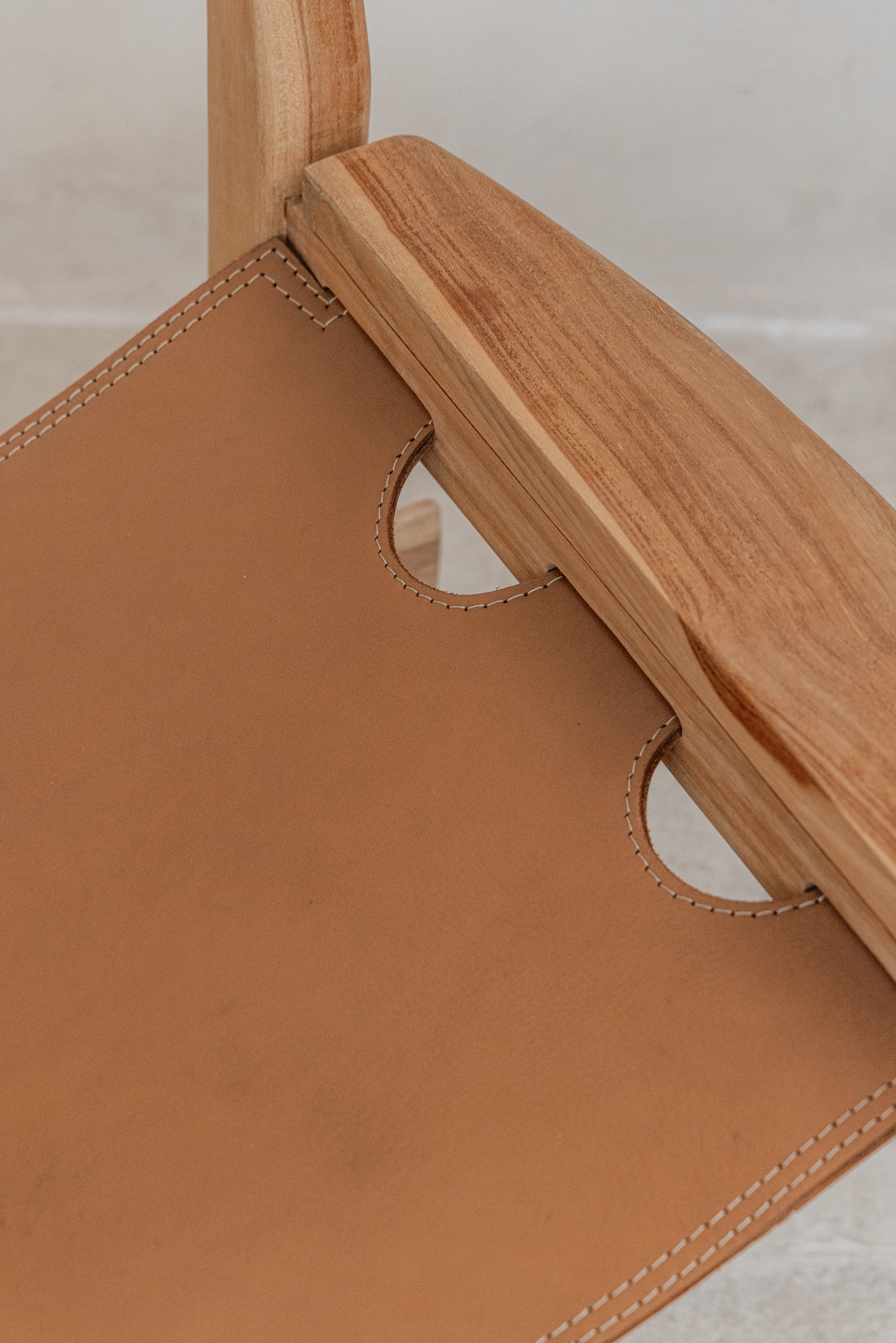 Close up of the hand stitched leather seat on the Sergio dining chair